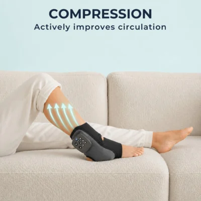 Woman lying on sofa with foot and ankle massager on leg, teal arrows showing compression actively moving fluid up the calf to improve circulation