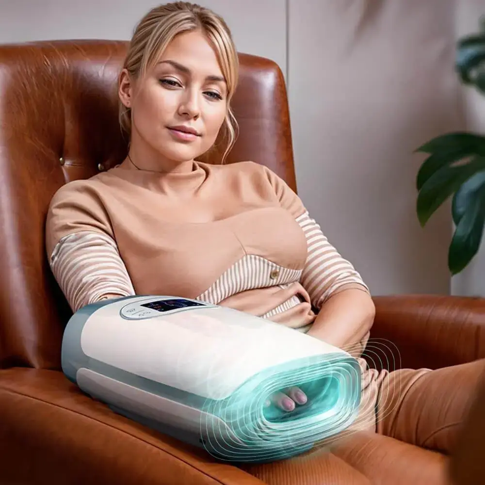Woman sitting and using the Hand Compression Massager.