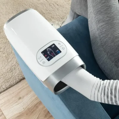 Photo of a female model using the Hand And Wrist Massager while seating in a sofa
